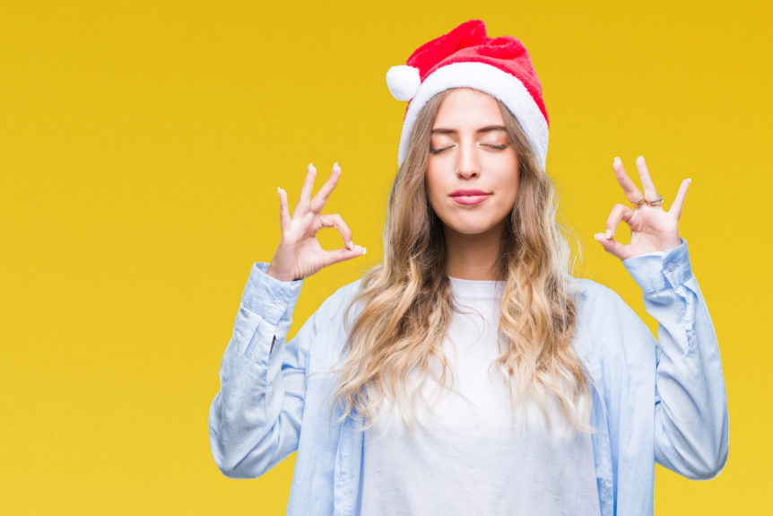 Woman practicing to de-stress the holidays with herbal remedies and meditation.