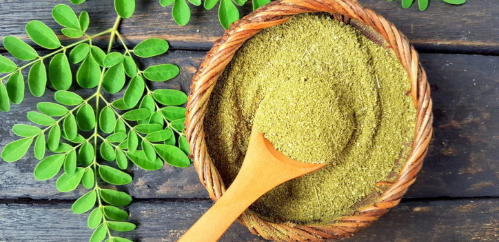 A wooden bowl of moringa powder for energy.