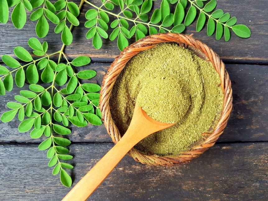 A wooden bowl of moringa powder for energy.