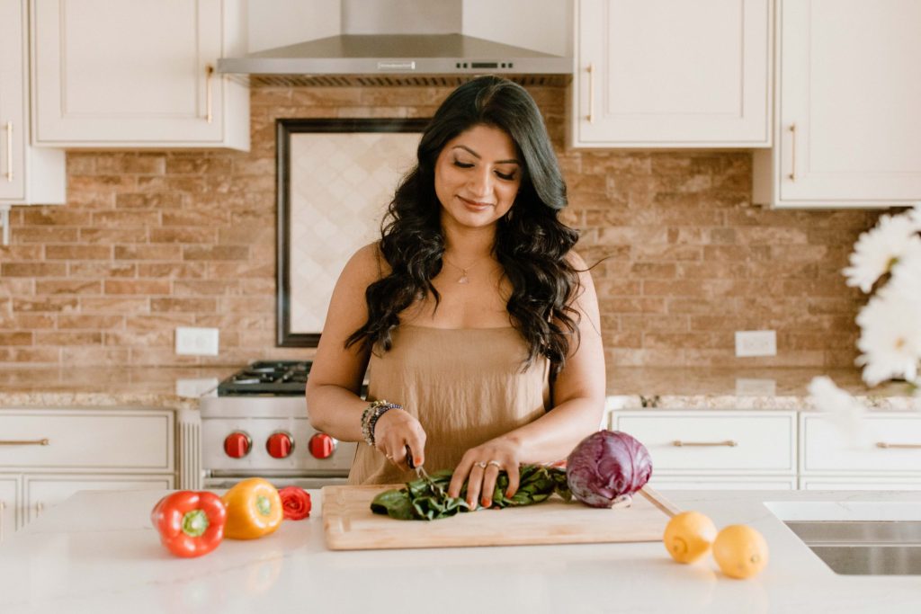 Radhika preparing a salad for her afternoon spring salad for cleansing daily ritual in Ayurveda for women