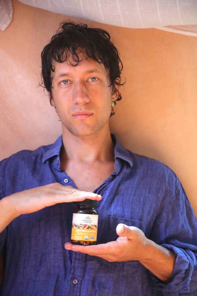 Man taking ashwagandha capsules for hair health