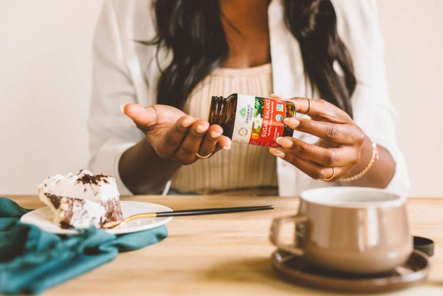 Woman taking sugar balance herbal supplement to help curb cravings naturally