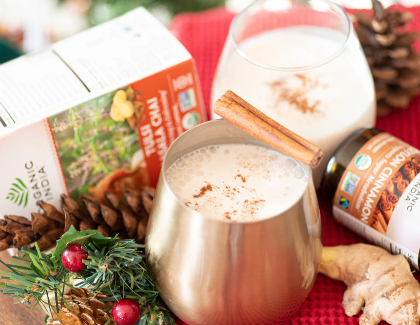 Chai spiced eggnog with holiday wreath, pinecones and cinnamon sticks.