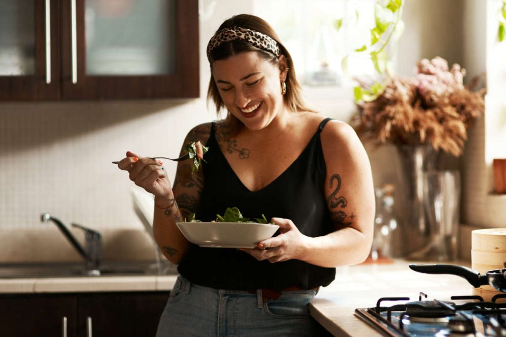 Woman enjoying a salad for every day whole being wellness.