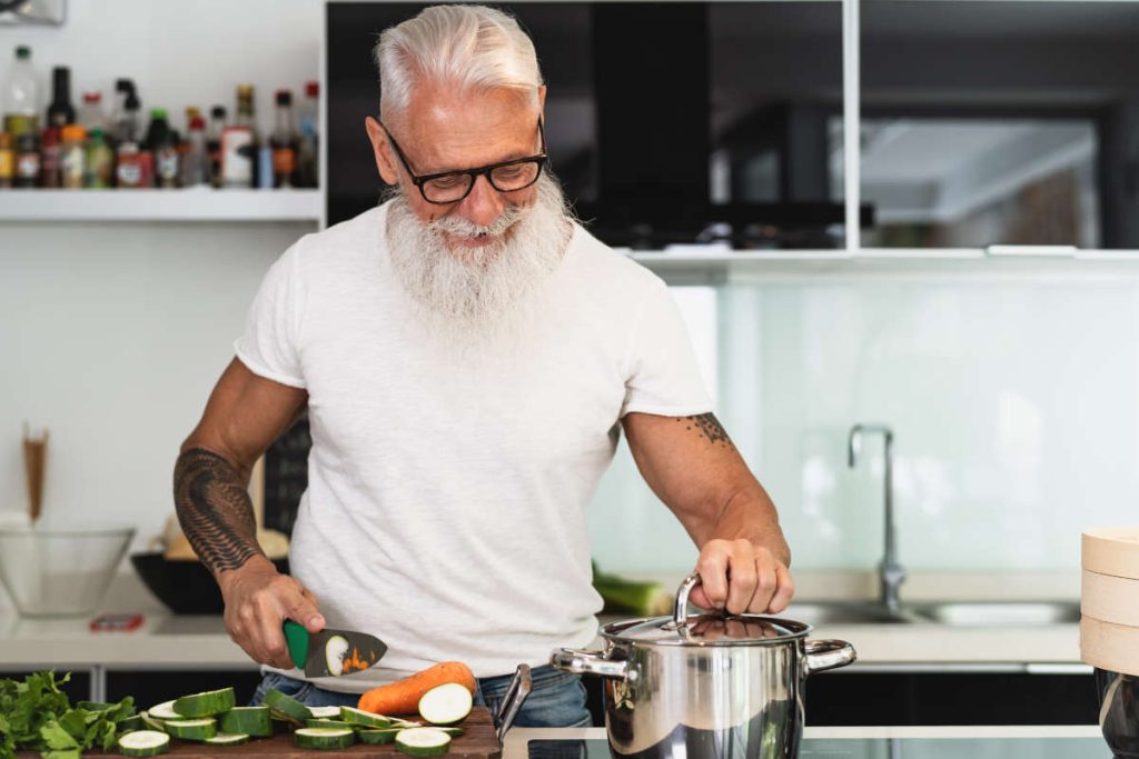 Old man preparing vegetables for gut and immunity