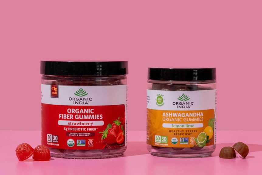 Ashwagandha and Fiber Herbal gummies on a pink table