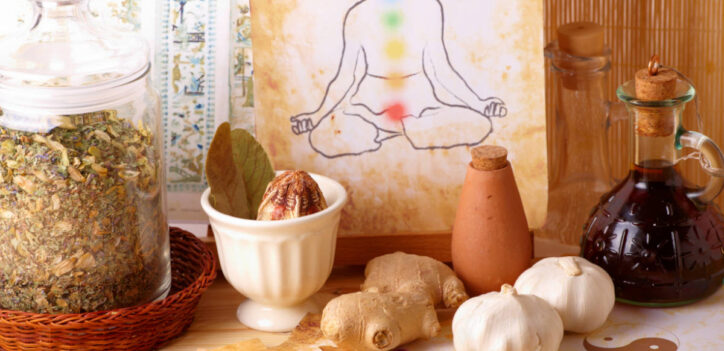 Herbs for the chakras with illustration of person and chakras on paper surrounded by herbs and roots.