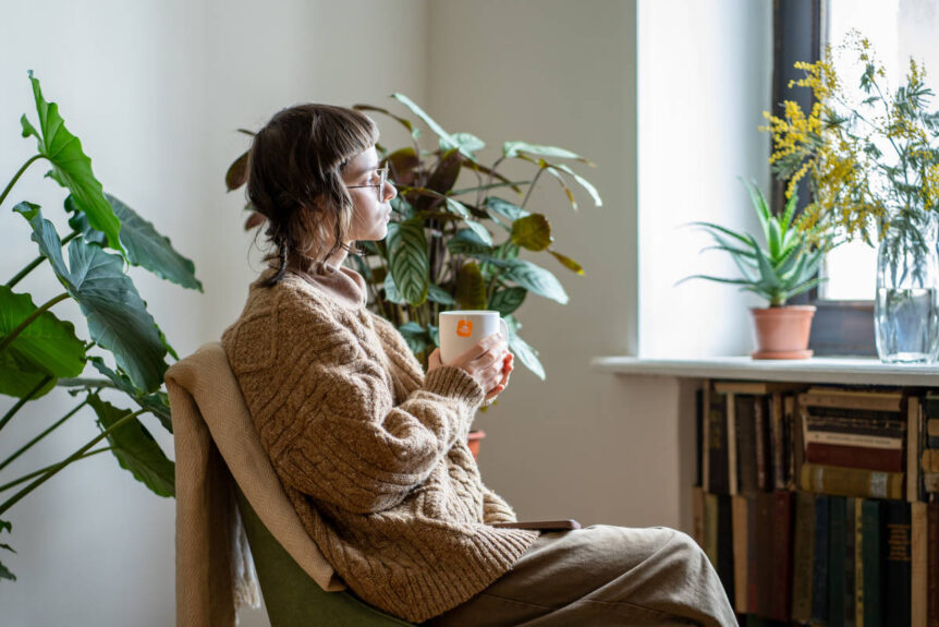 Woman drinking tulsi ashwagandha tea for hormonal balance