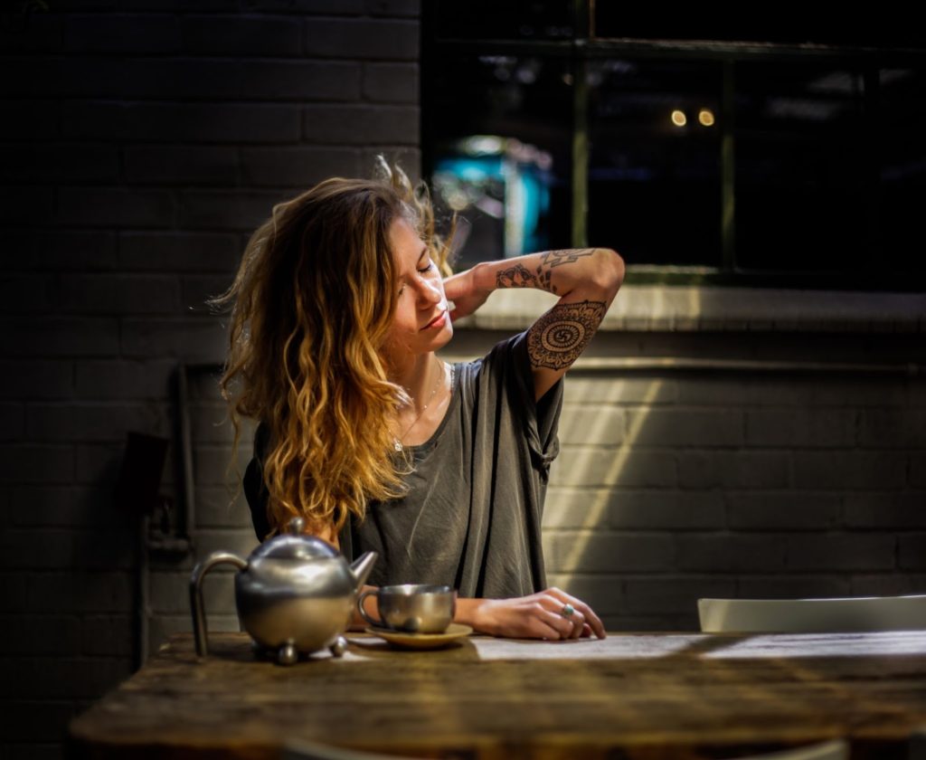 Woman stressed, drinking herbal tea for support