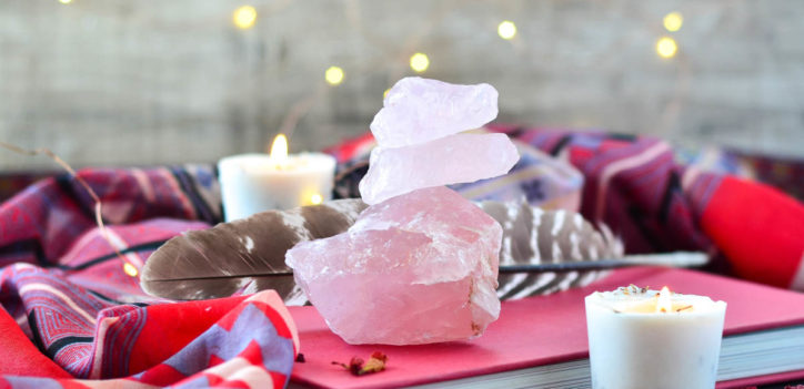 book, crystals and candles for an intention setting ritual.
