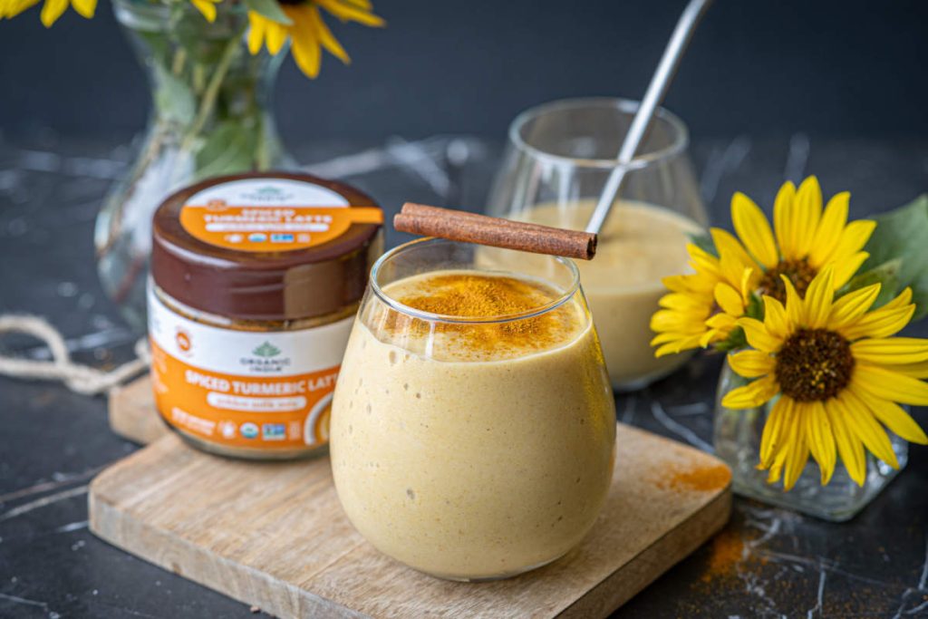 Turmeric lassi with turmeric garnish on cutting board