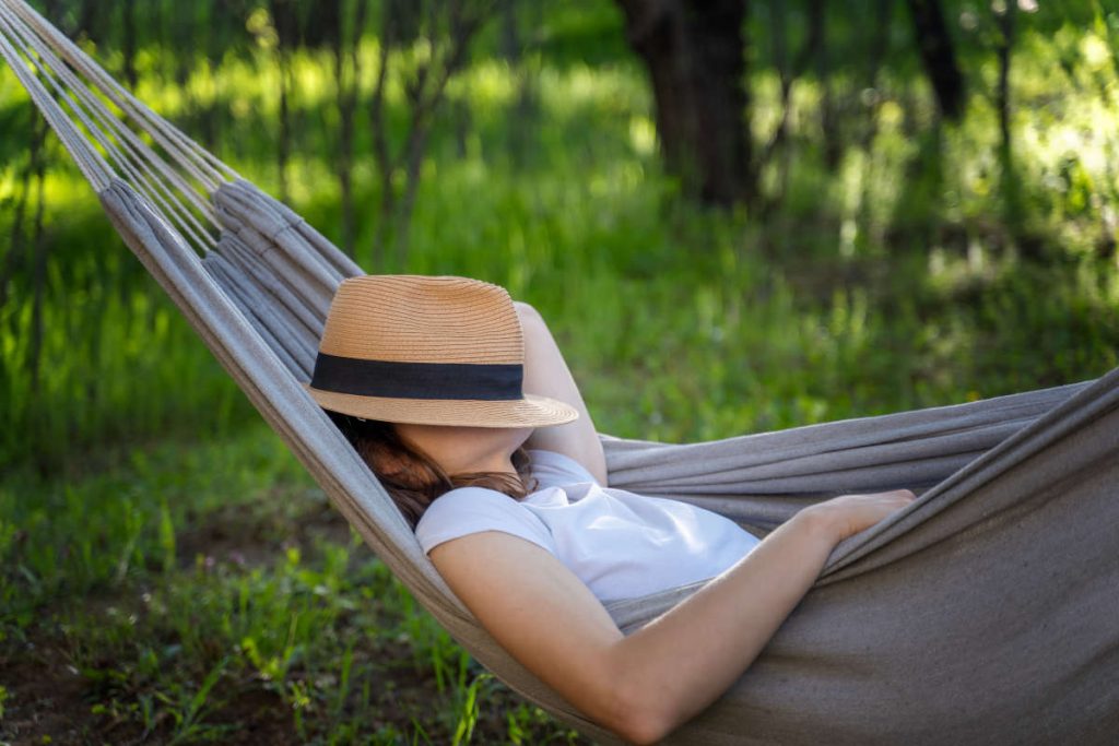 Woman resting in nature for late summer ayurveda ritual