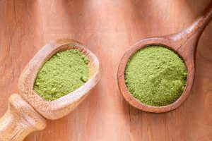 Matcha vs moringa on wooden spoons