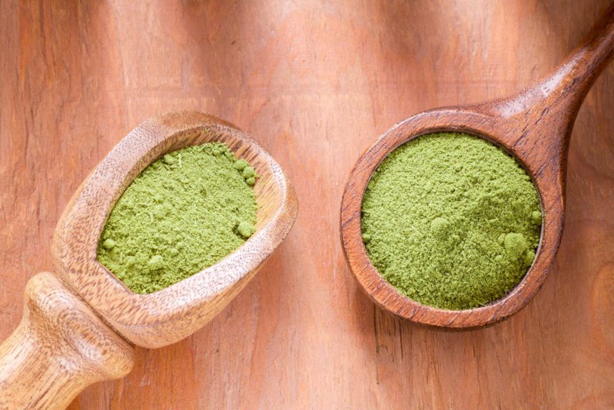Matcha vs moringa on wooden spoons