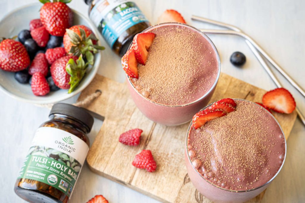 Mood boosting smoothie with berry, cacao, and herbal supplement boosters.