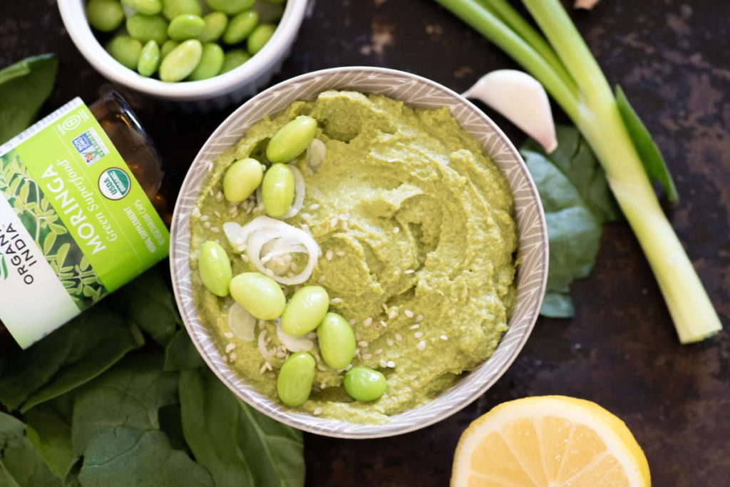 Moringa Misa edamame dip in a bowel with fresh green onion and edamame garnish