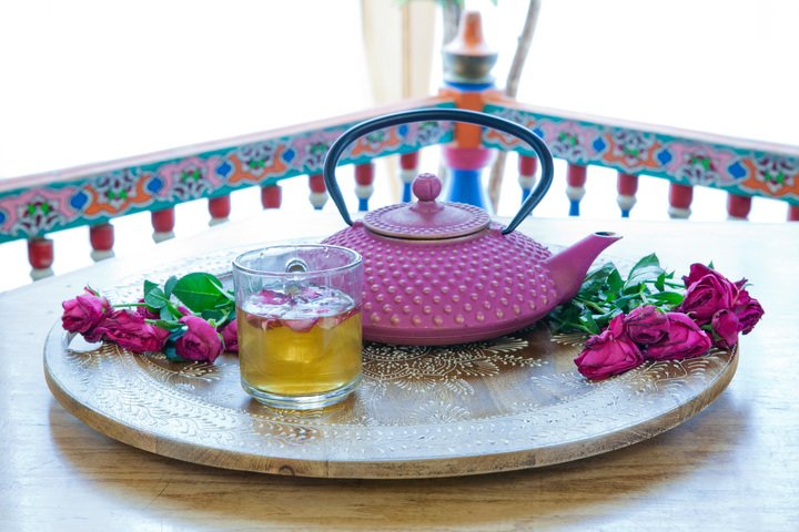 Spirit of rose iced tea with pink cast iron tea kettle.