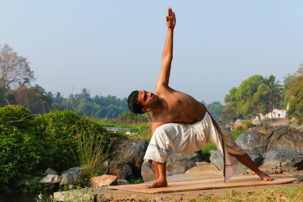 Man practicing yoga outside