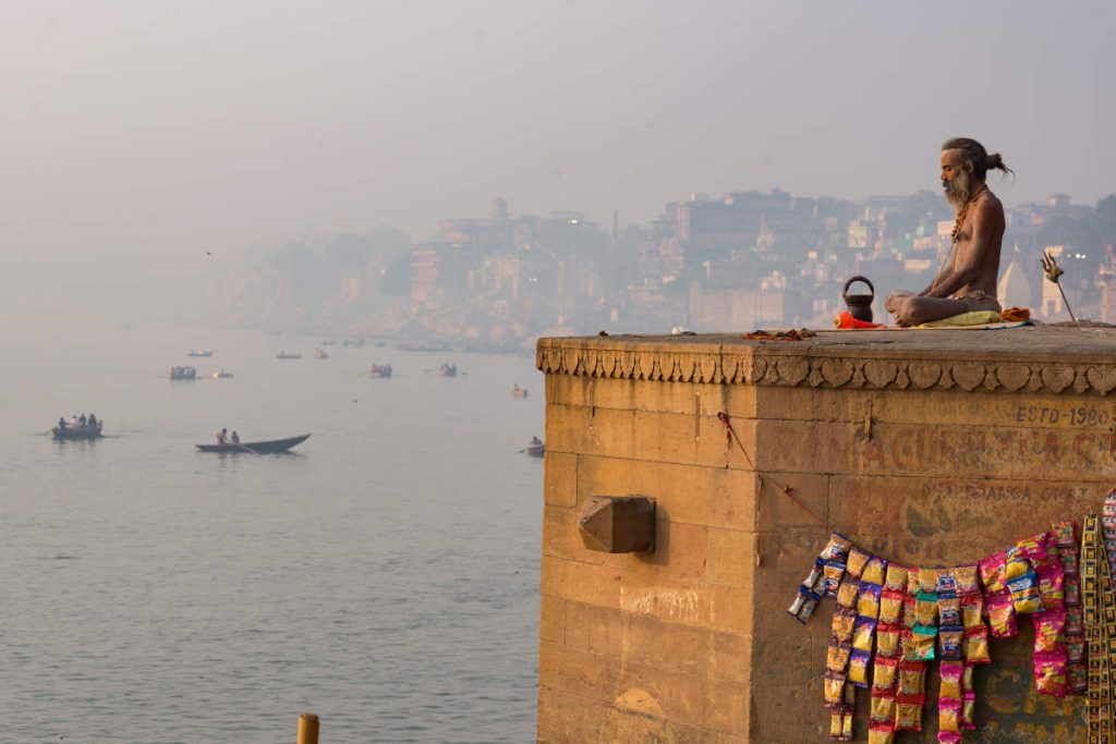 Men on a rooftop in India practicing meditation