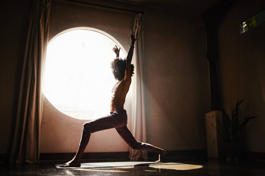 Osiris booque high crescent pose in front of circular window