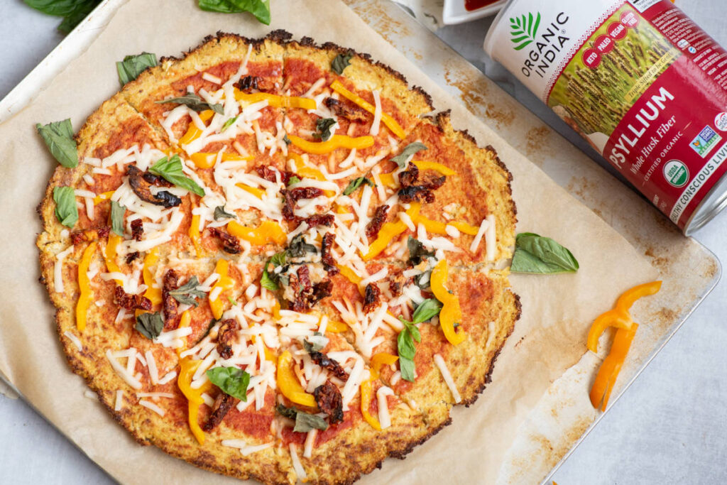 cauliflower psyllium pizza crust topped with vegan cheese, basil and sundried tomatoes.