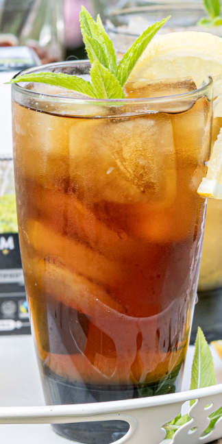 ROC™ Black Iced Tea in a tall glass with mint garnish