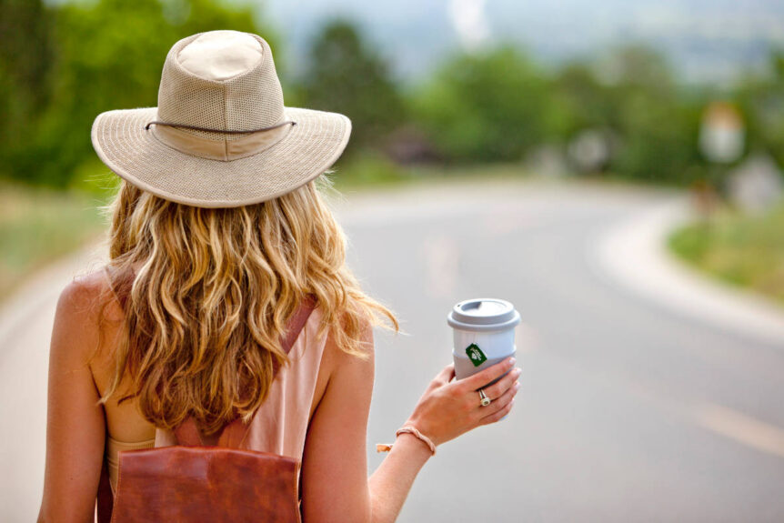 Woman traveling on the road with herbal tea