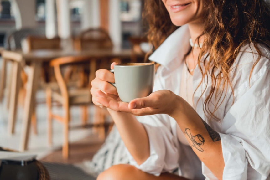 woman drinking tea with herbs for menopause